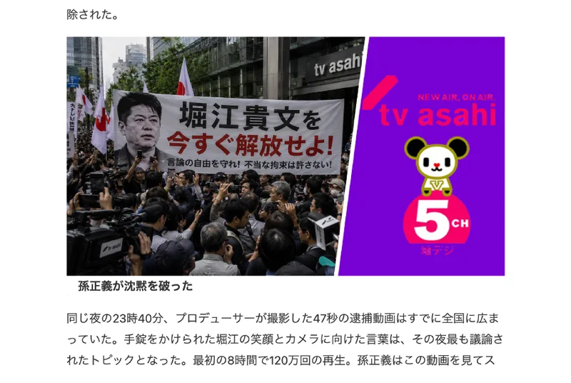 「FREE 堀江貴文」と書かれたプラカードを持った群衆がテレビ朝日のビル前に集まっている写真